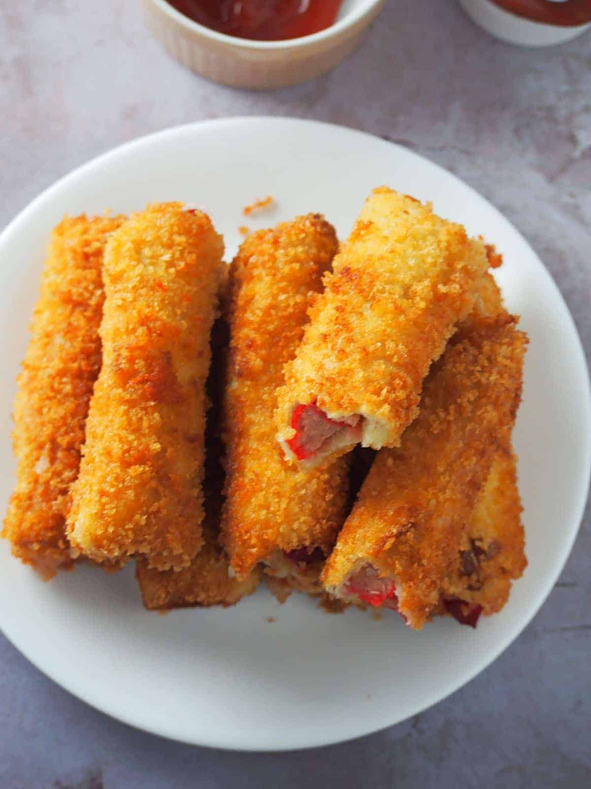 cheese dog bread rolls on a white plate