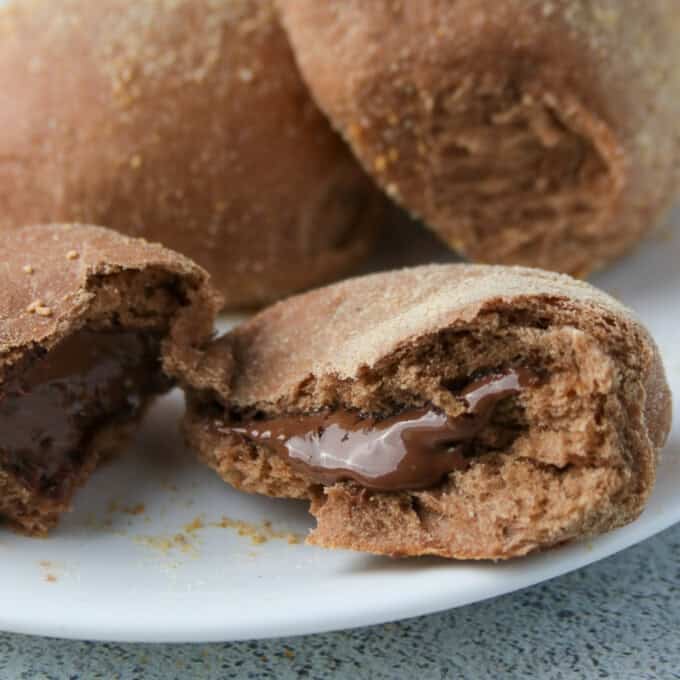 chocolate pandesal with Nutella filling on a white plate.