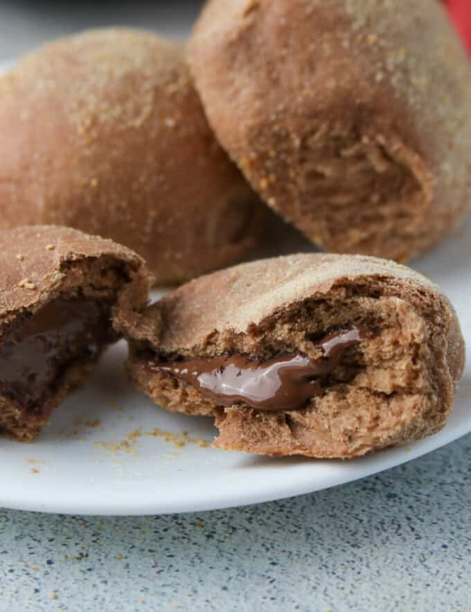 chocolate pandesal with Nutella filling on a white plate.