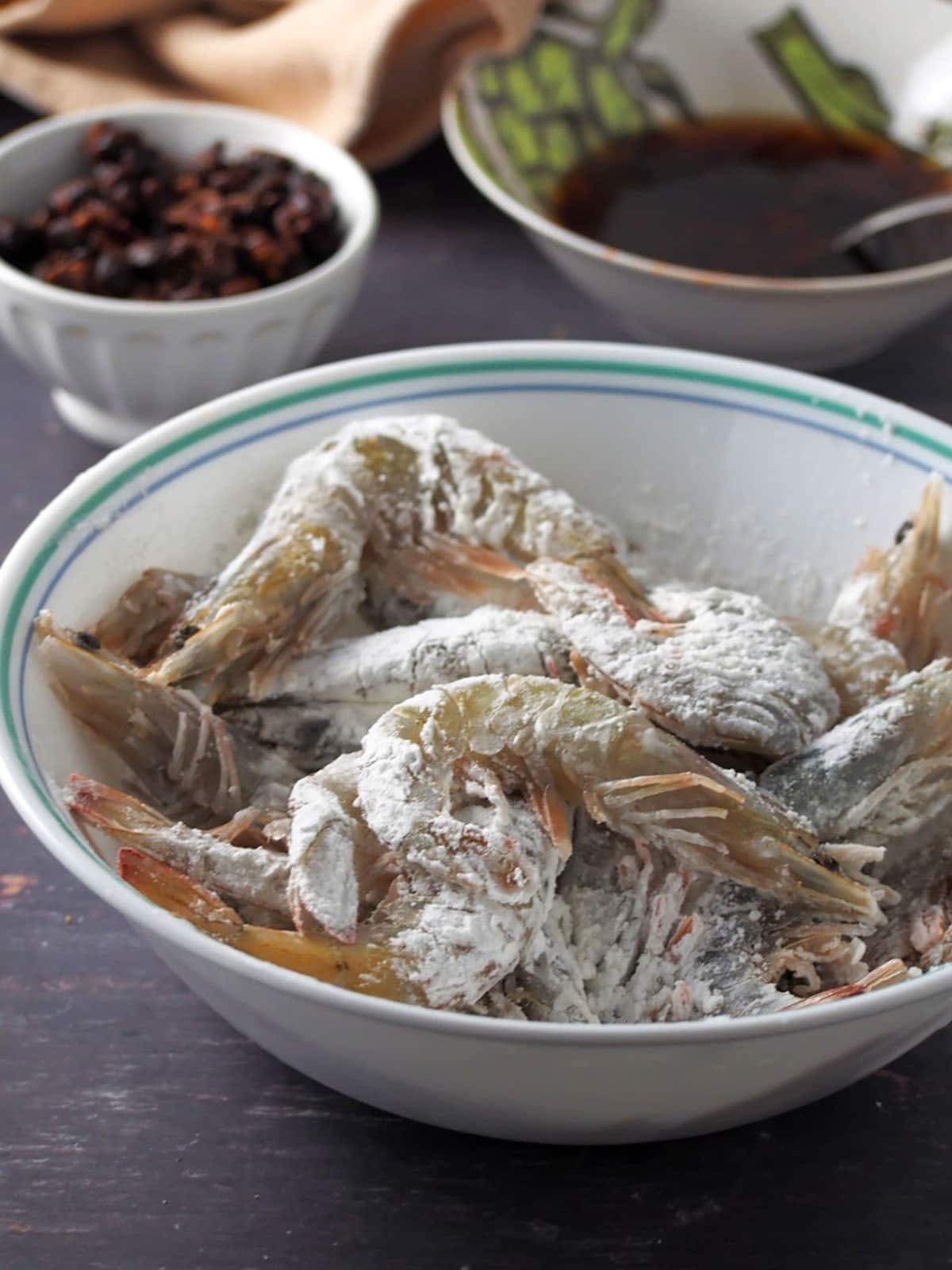 shrimp coated with cornstarch in a bowl