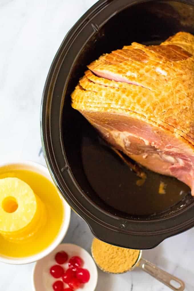 spiral ham in the crockpot, maraschino cherries, pineapple rings, brown sugar in bowls