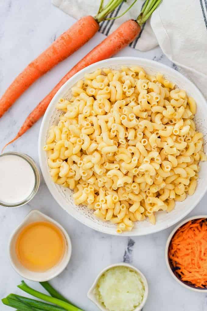 cooked elbow macaroni, carrots, chopped onions, shredded carrots, mayonnaise, apple cider vinegar