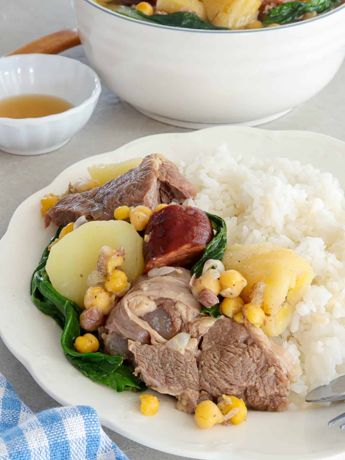 cocido-style-nilaga on white plate with steamed rice on the side.