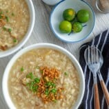 bowls of Goto with fried garlic and chopped green onions