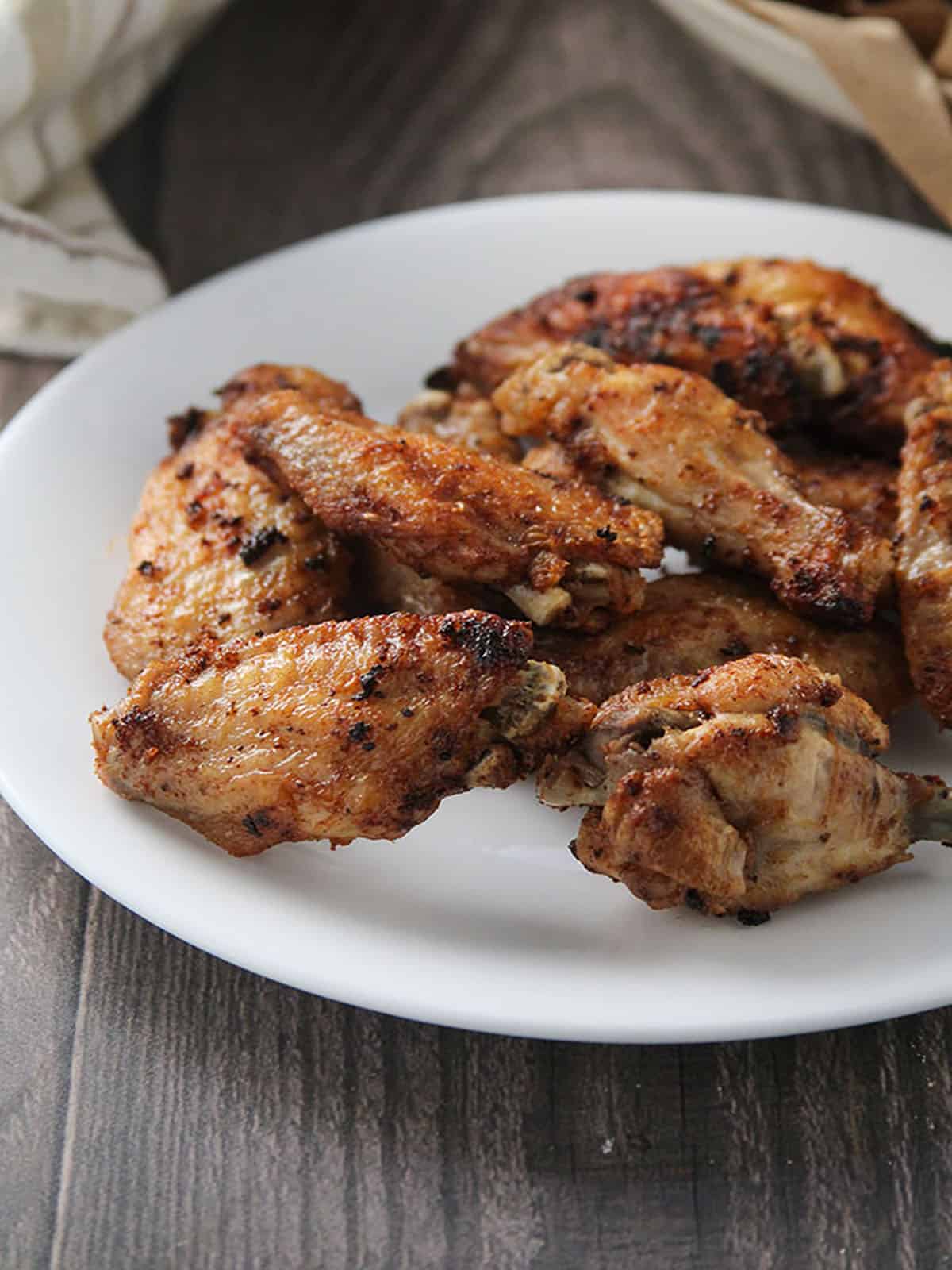 tamarind chicken wings on a white plate