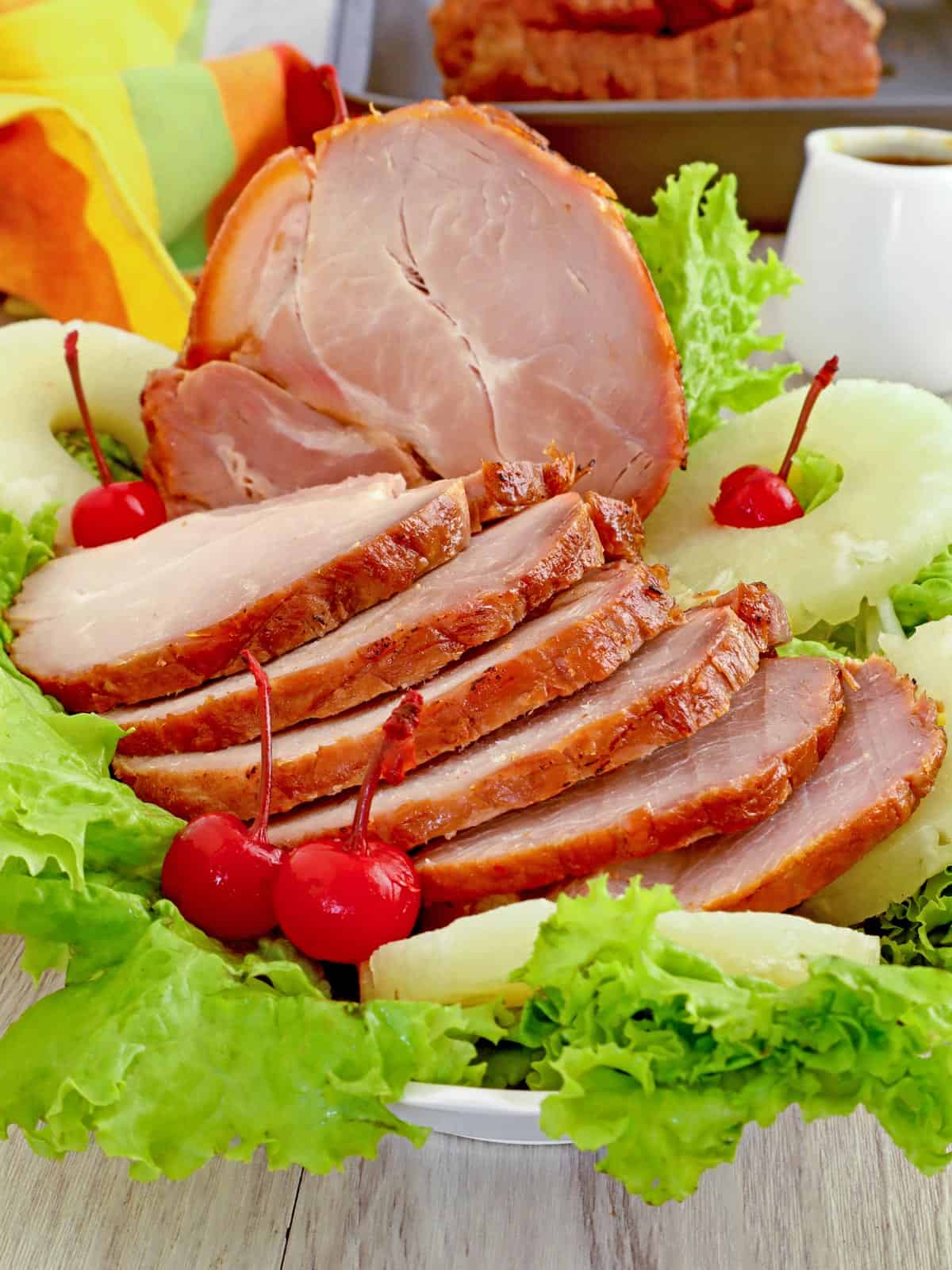 sliced ham on a platter with pineapple rings