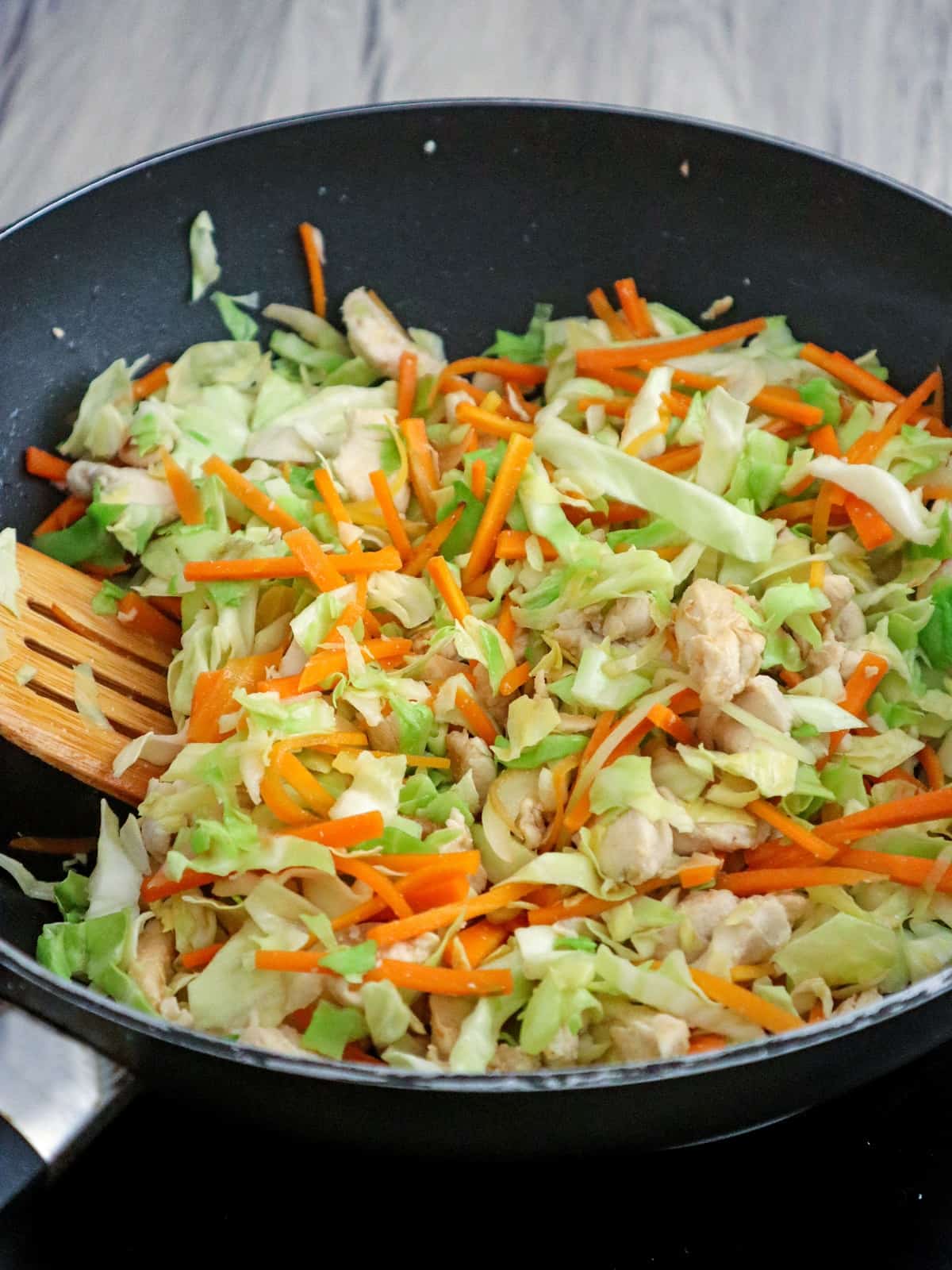 stir-frying vegetables in a wok