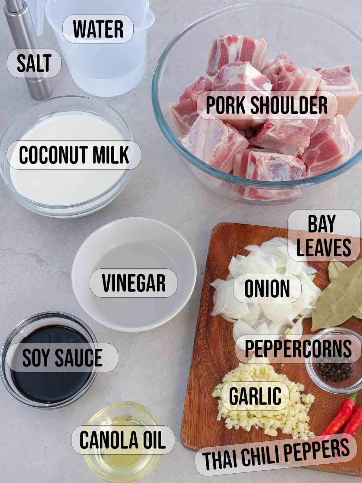 pork cubes, coconut milk, salt, peppercorns, garlic, onions, bay leaves, vinegar, soy sauce, oil, water, chili peppers.