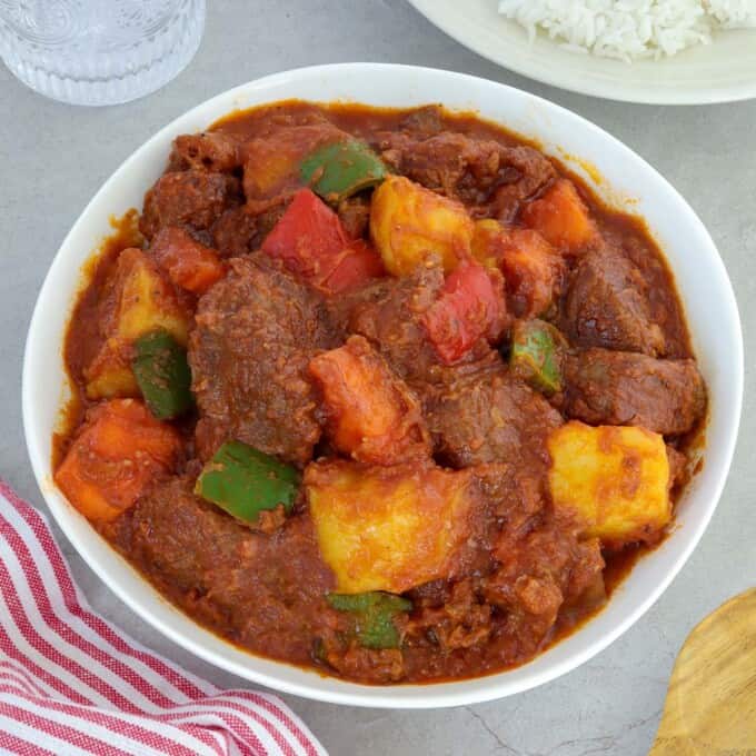Beef Afritada in a white serving bowl