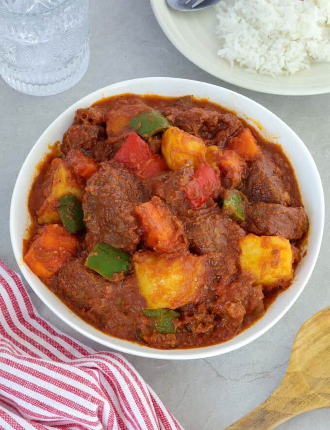 Beef Afritada in a white serving bowl