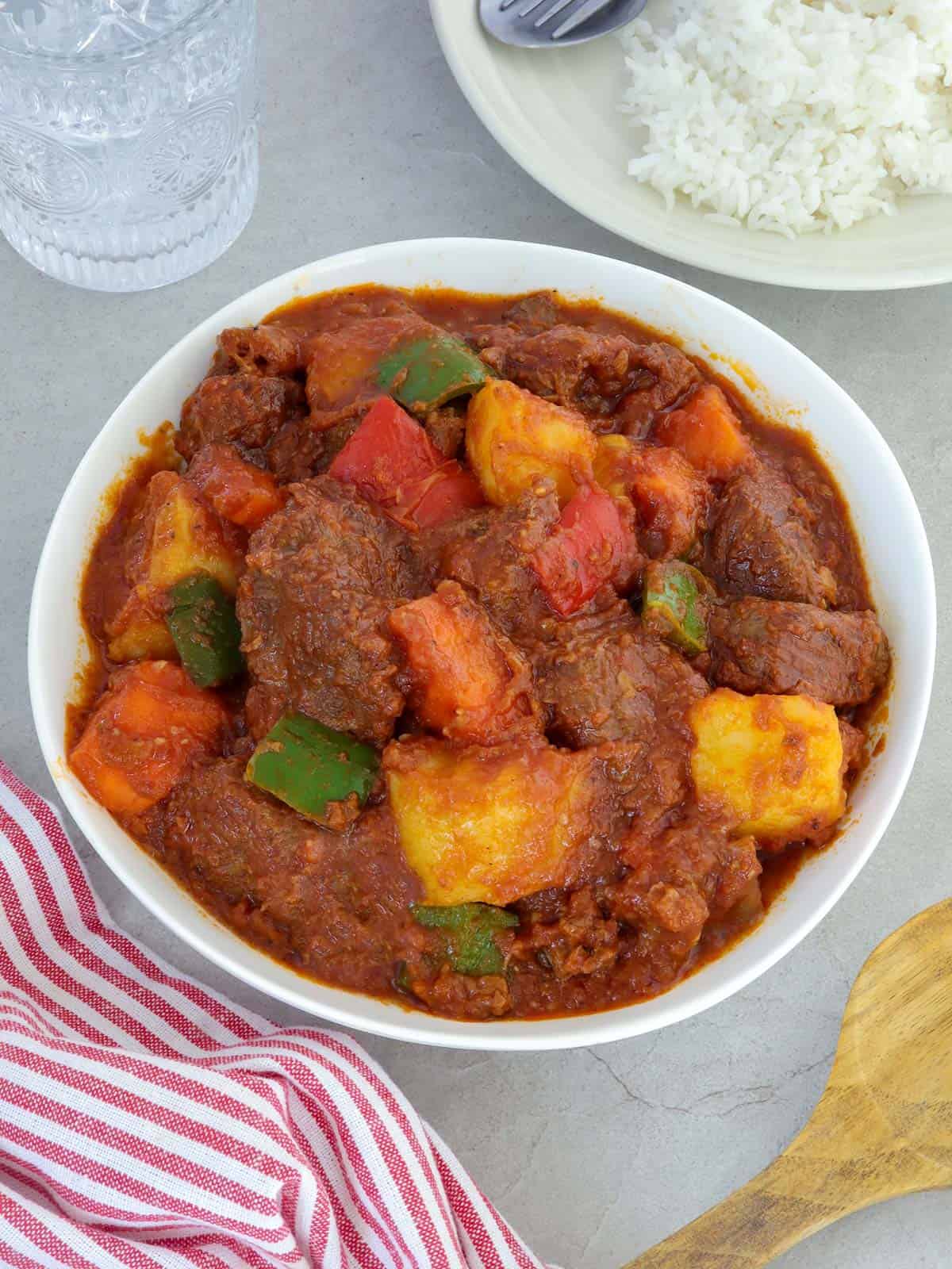 Beef Afritada in a white serving bowl