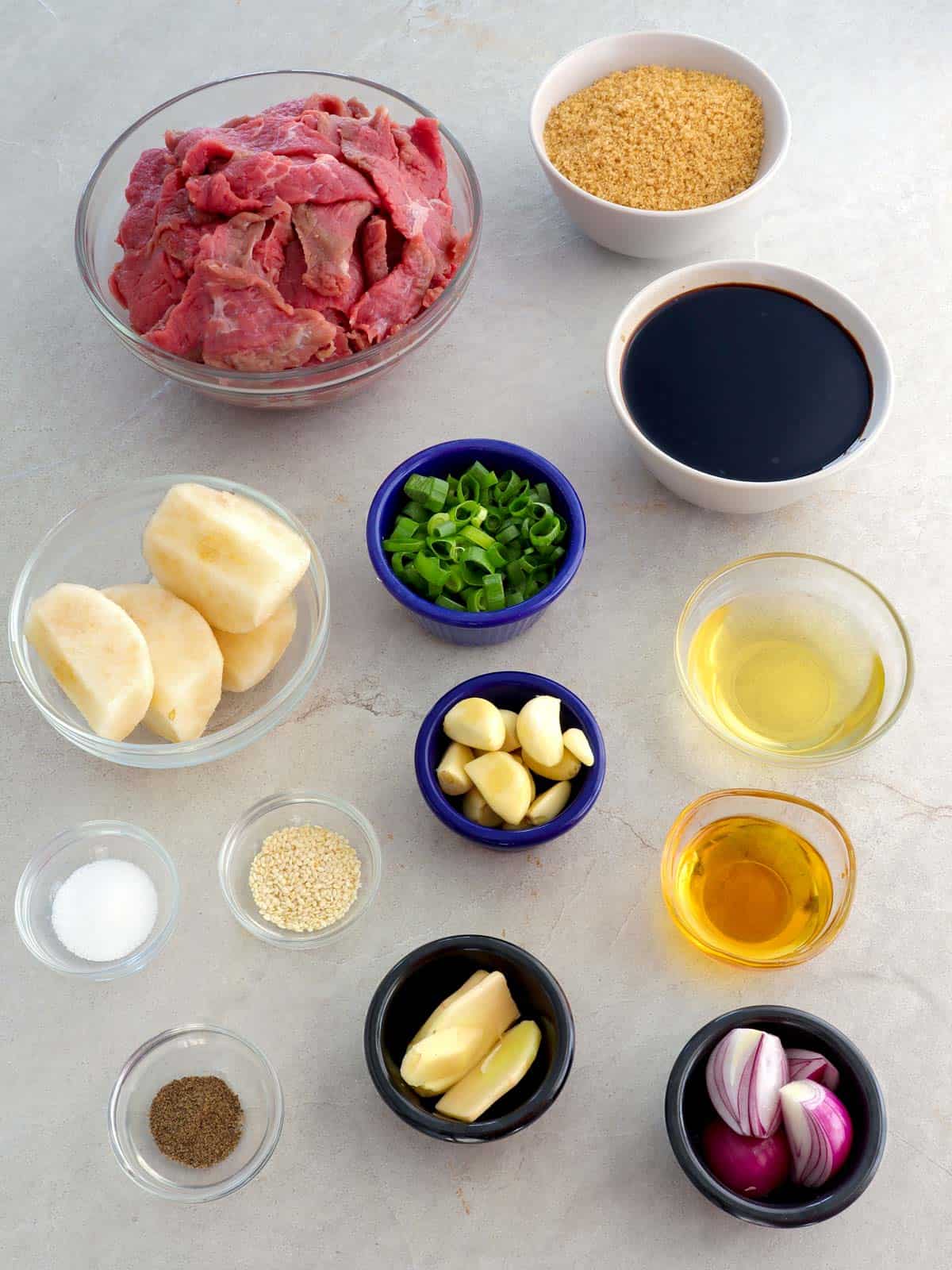 sliced beef and marinade ingredients in bowls