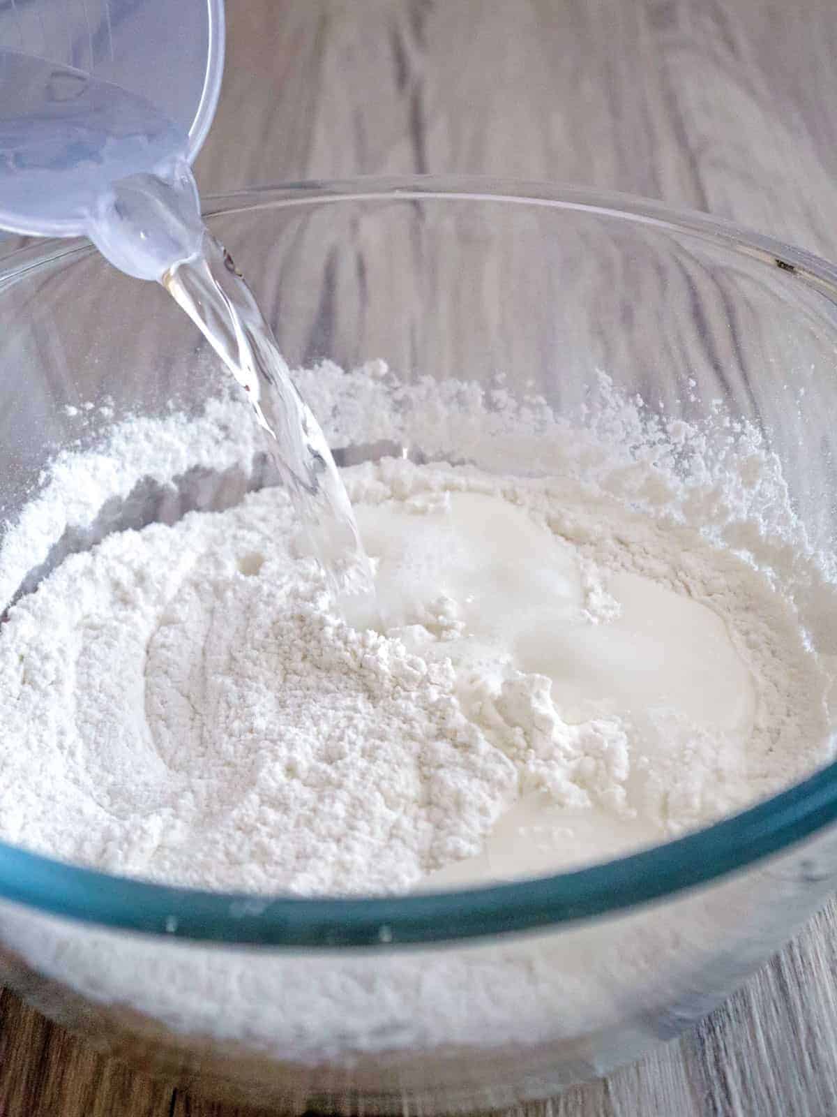 pouring water to a bowl of glutinous rice flour