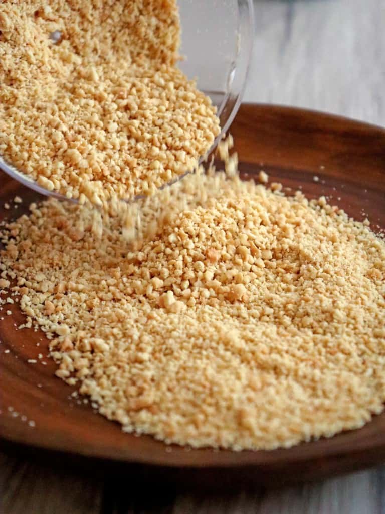 pouring ground peanuts to a brown plate