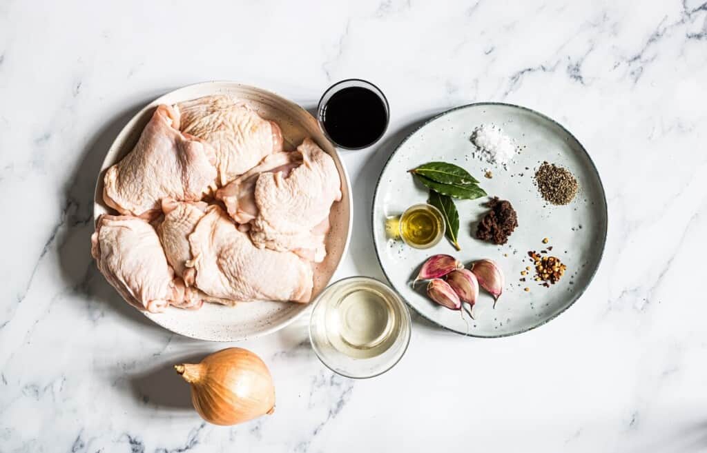 cut up chicken, bay leaves, garlic, onions, salt, pepper, soy sauce, vinegar