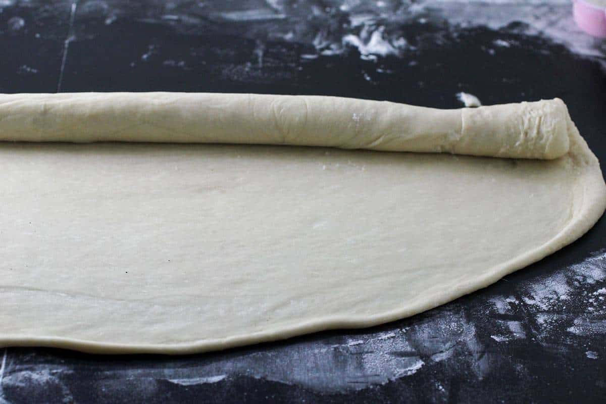 rolling the dough into a cylindrical log