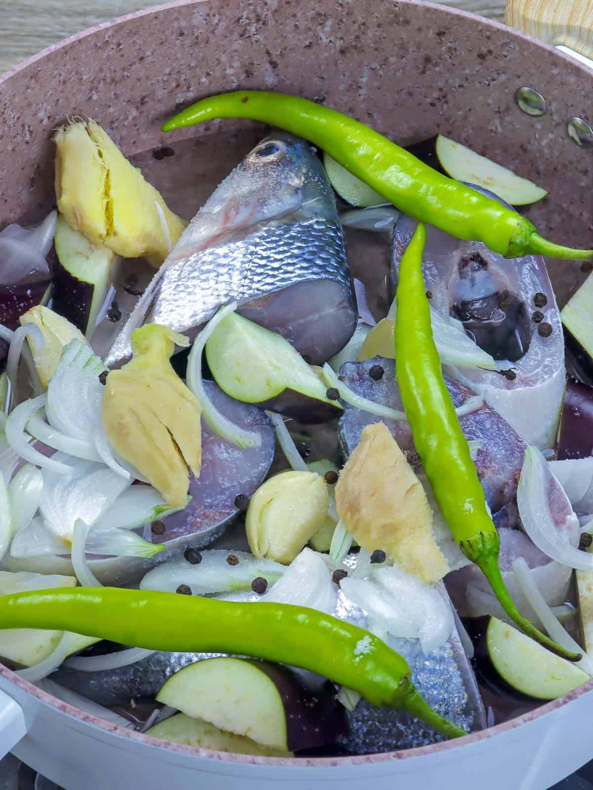 cooking Paksiw na Bangus in a pot