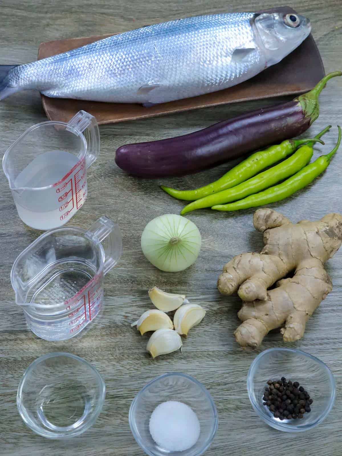 milkfish, ginger, garlic, onion, chili peppers, vinegar, salt, pepper, eggplants, oil