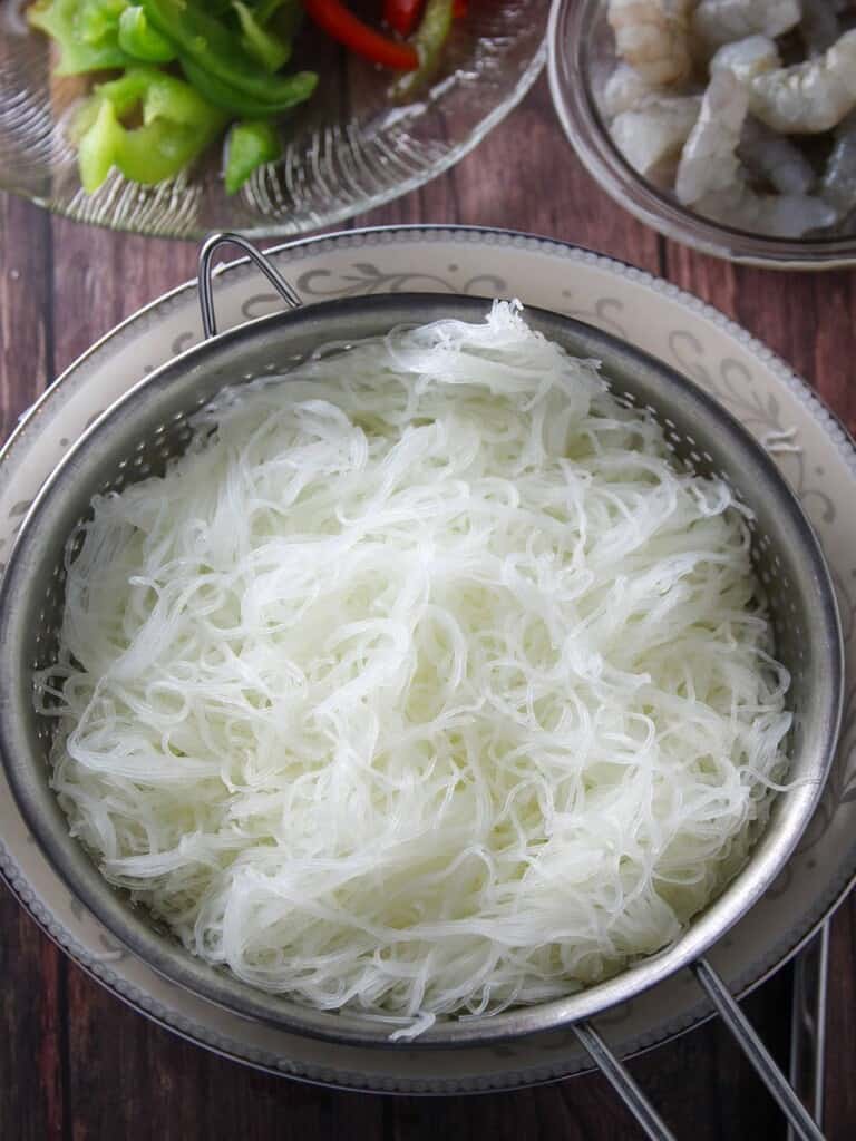 soaked and drained rice vermicelli noodles in a colander