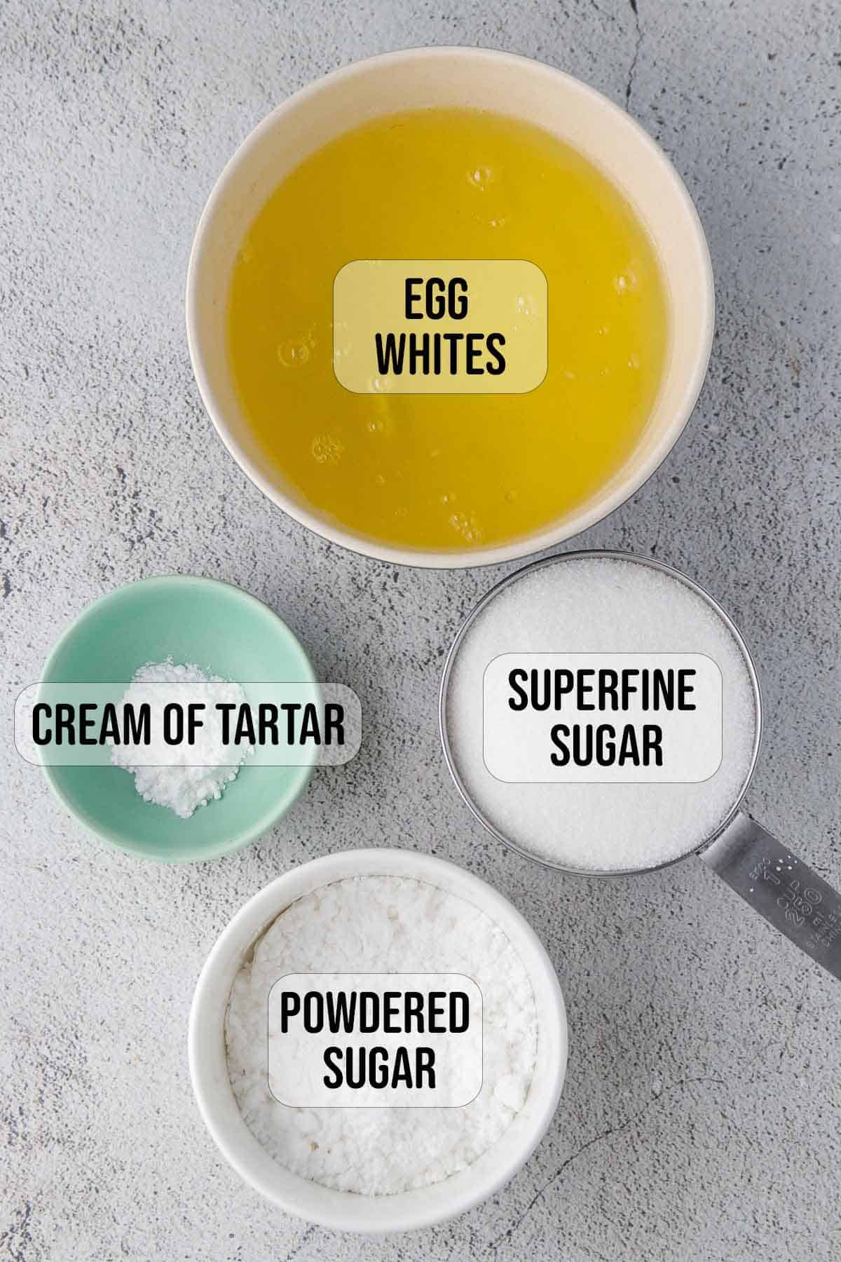 egg whites, superfine sugar, cream of tartar, powdered sugar in bowls to make meringue.
