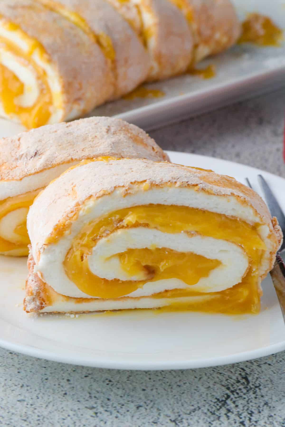 slices of Brazo de Mercedes on a white plate.