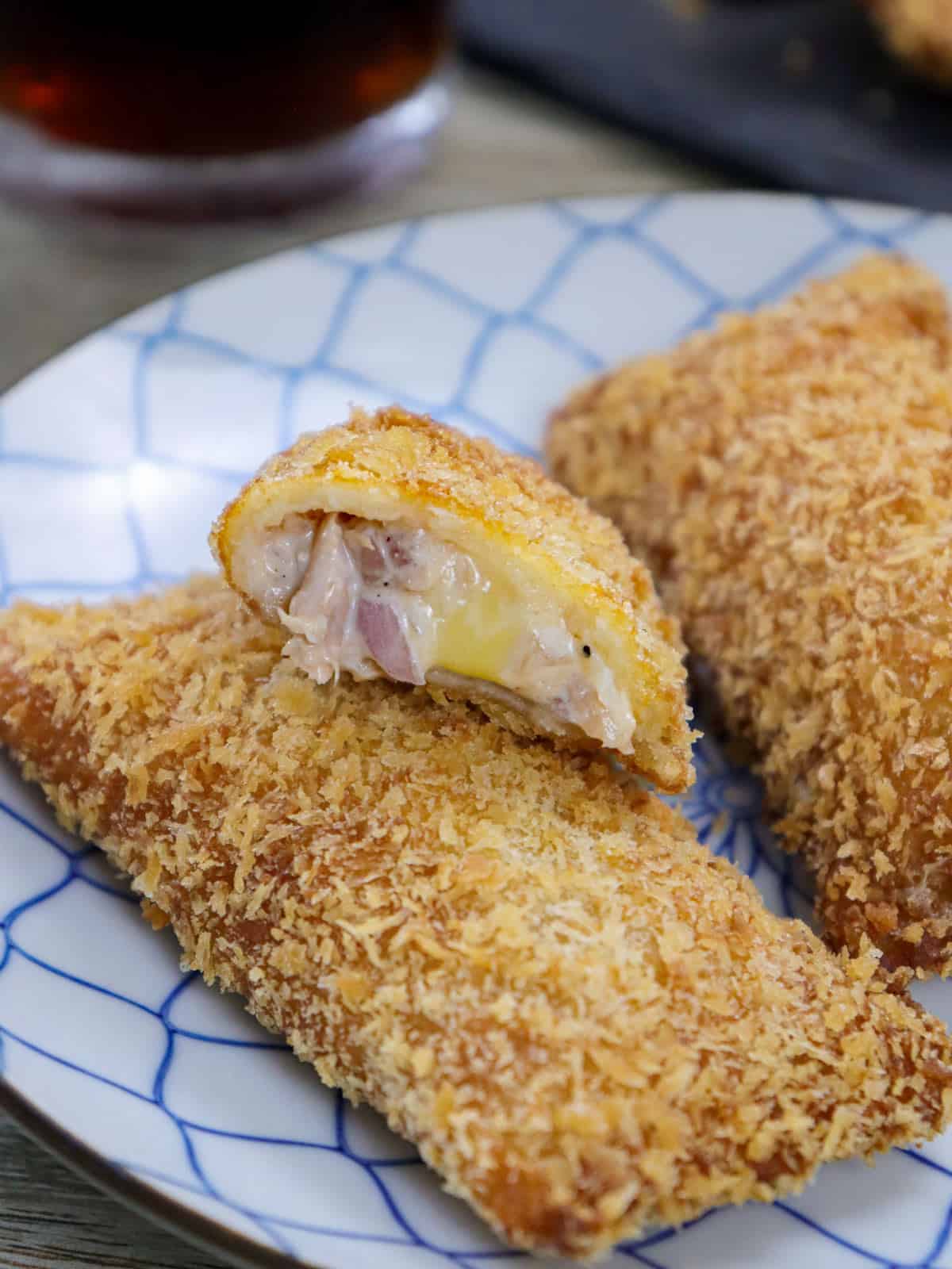 crispy tuna pocket pies showing filling on a serving plate.