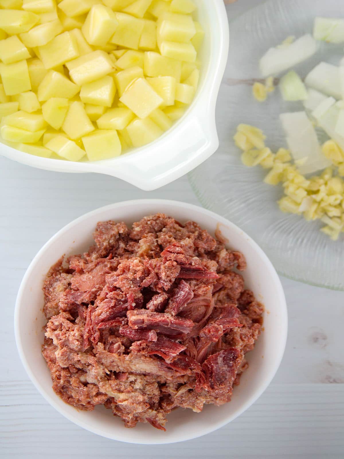 canned corned beef, diced potatoes, chopped onions, minced garlic