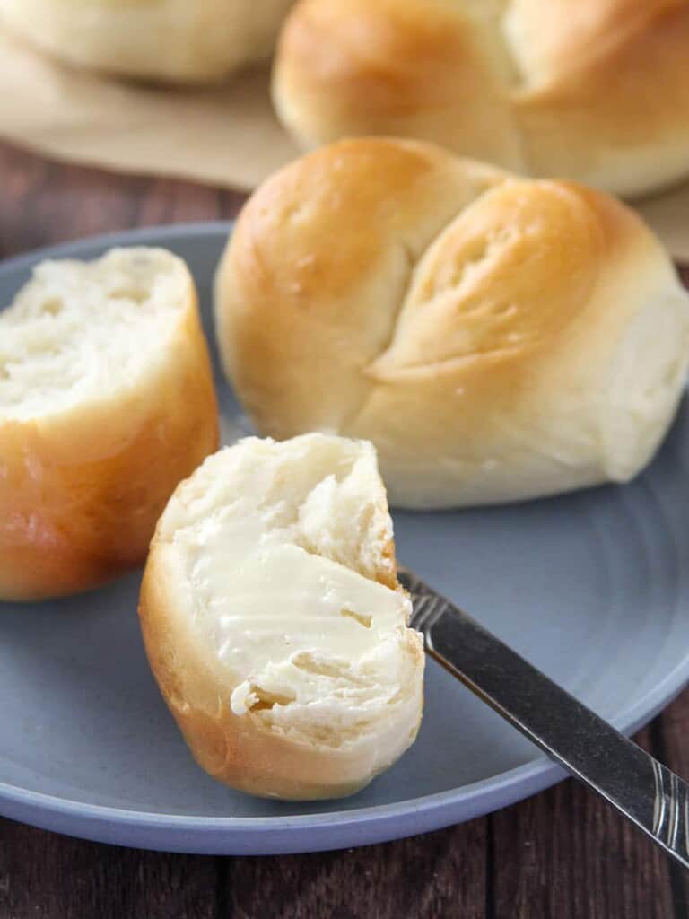 Monay with butter on a plate