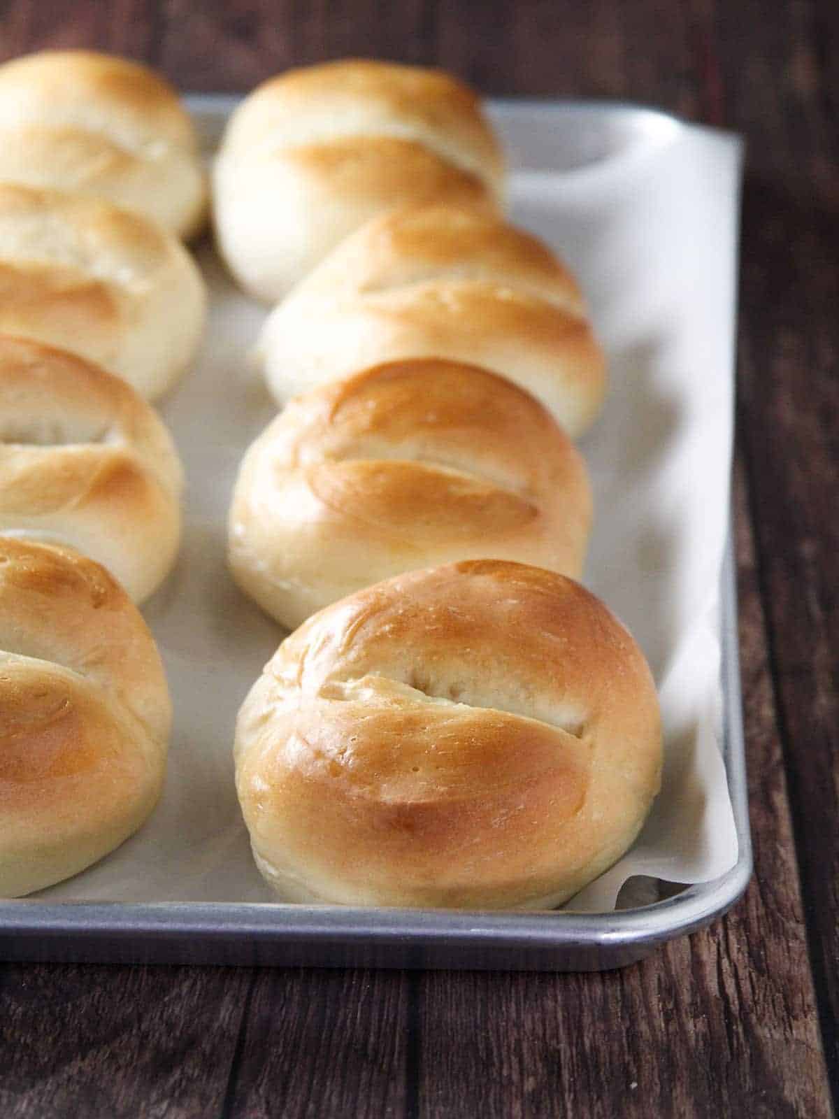 Pan de monja on a parchment-lined baking sheet