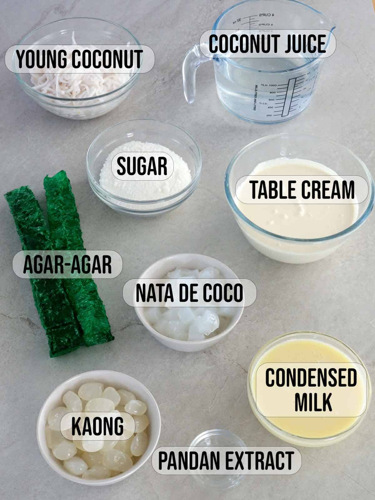 shredded young coconut, agar-agar bars, kaong, nata de coco, condensed milk, coconut juice, all-purpose cream in bowls.