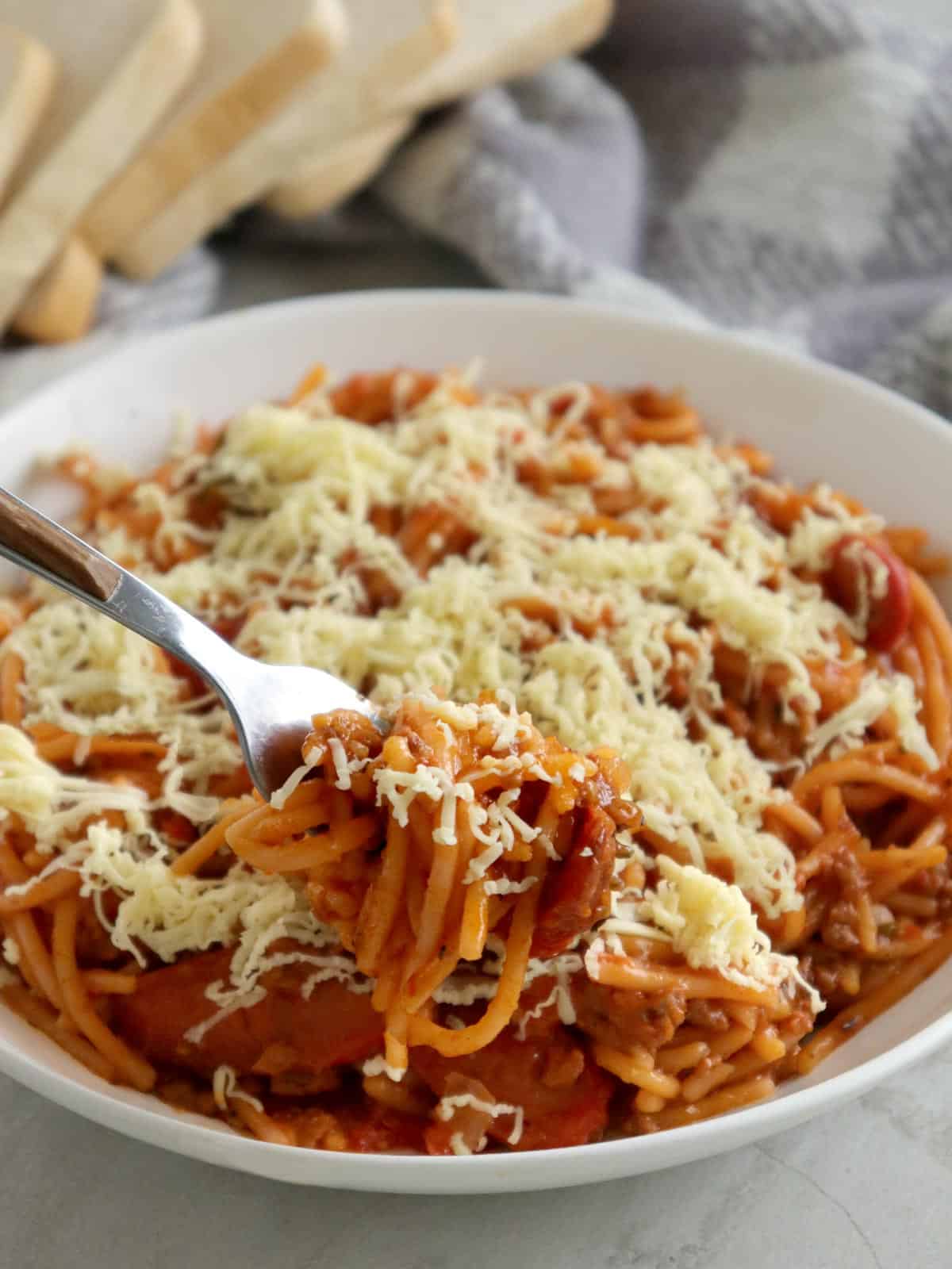 eating Pressure Cooker Filipino Spaghetti with a fork