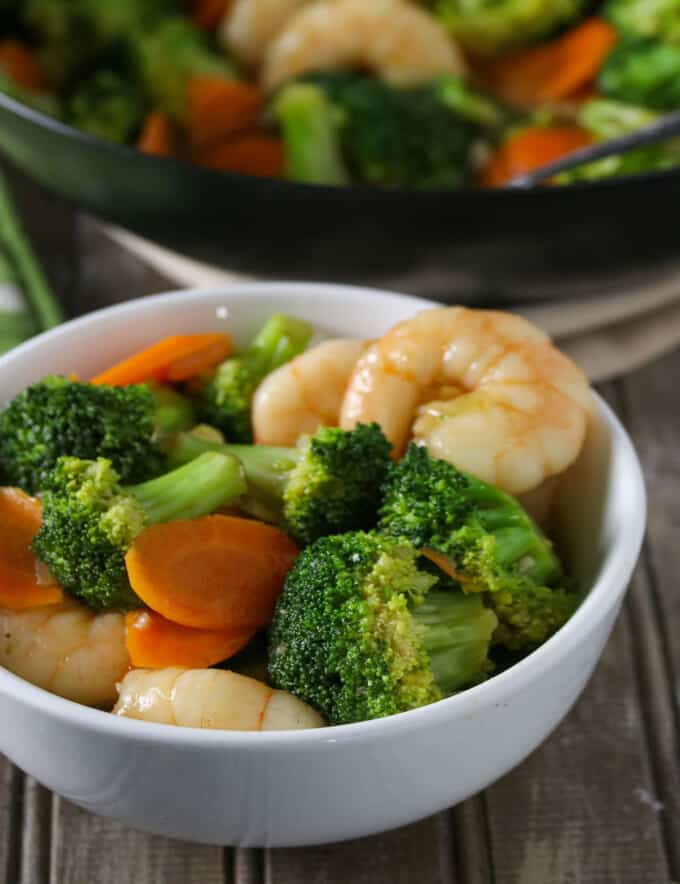 broccoli and shrimp stir-fry in a white bowl