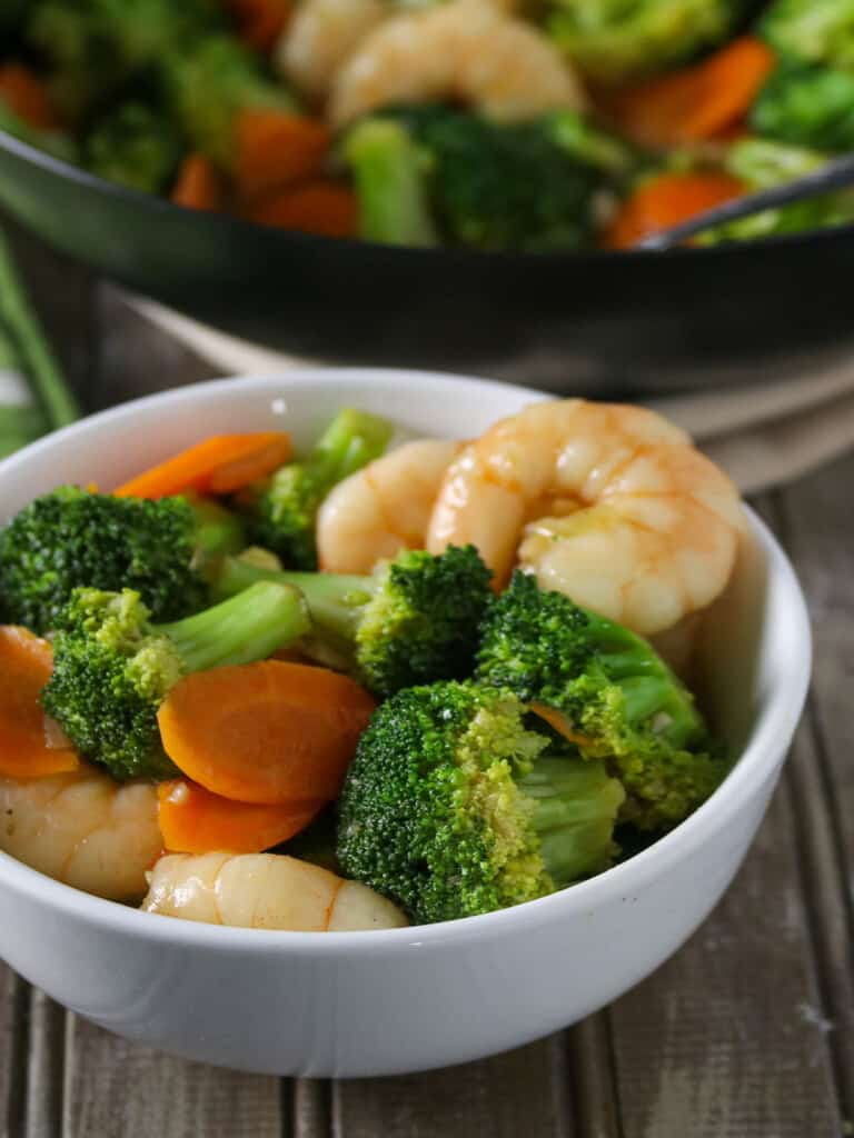 broccoli and shrimp stir-fry in a white bowl