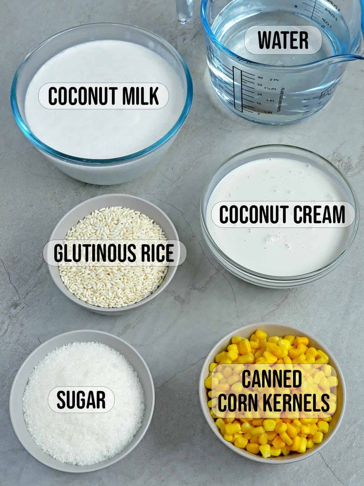 corn kernels, coconut milk, glutinous rice, sugar, water in bowls.