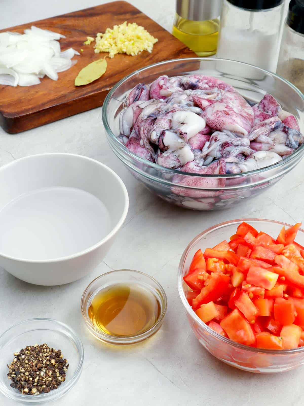 squid, vinegar, tomatoes, fish sauce, pepper, onions, ginger, bay leaf