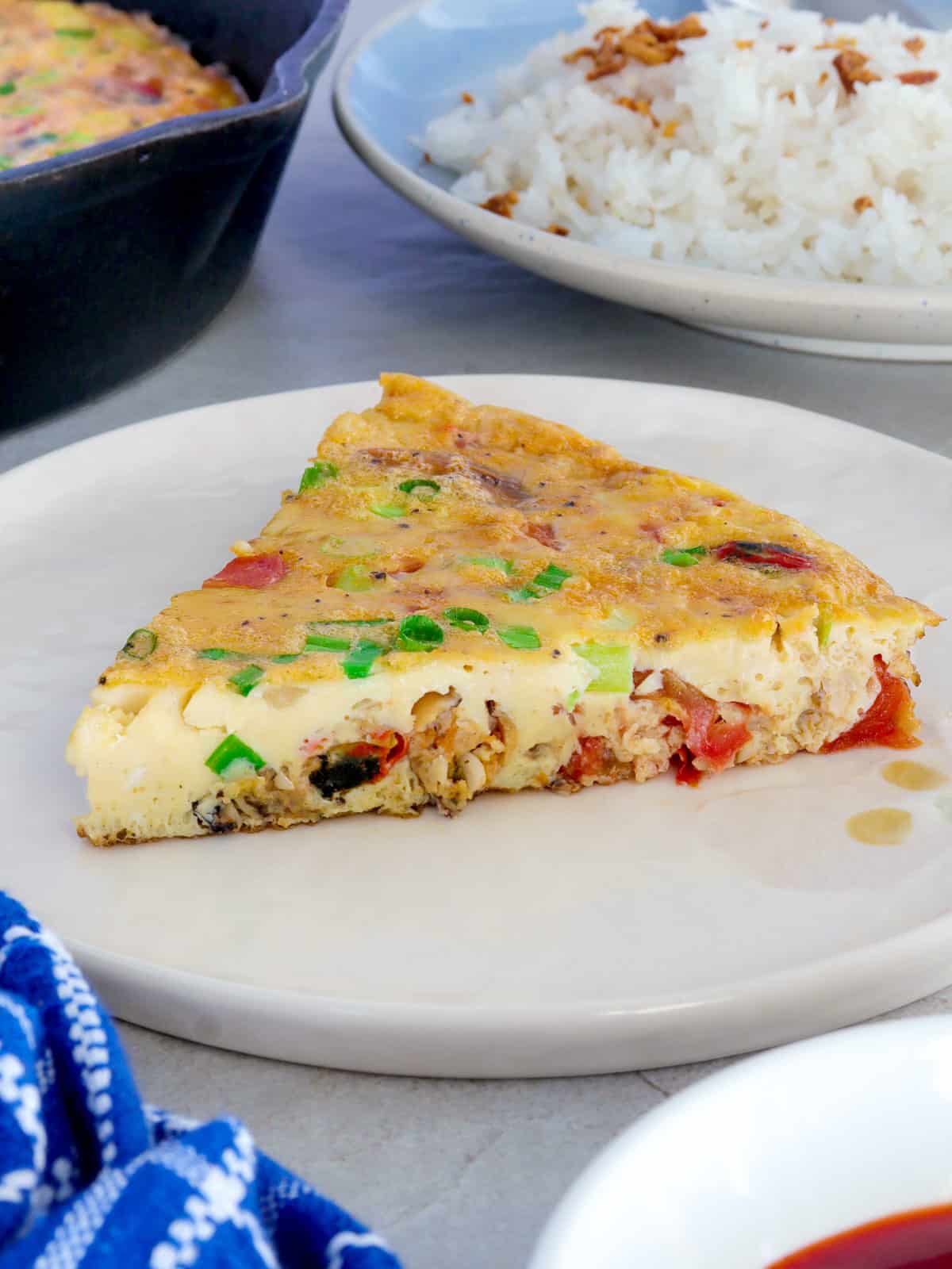 slice of mussel omelet on a white plate