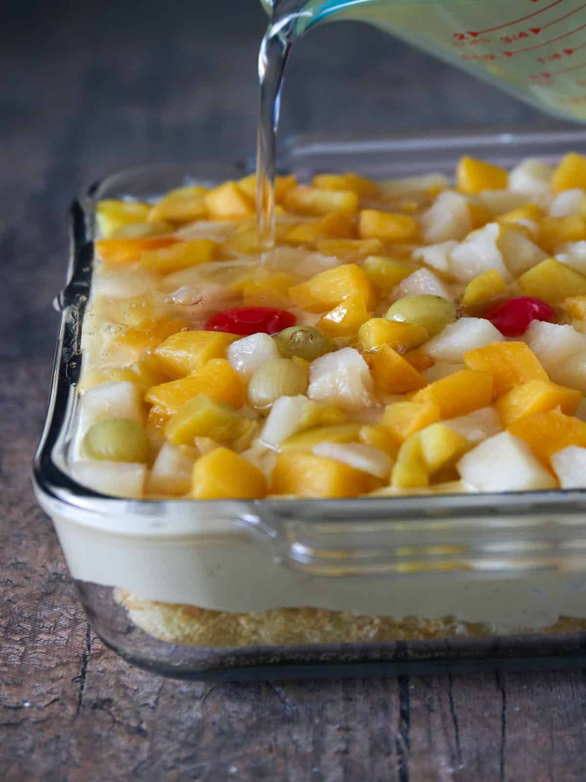 assembling crema de fruta in a glass dish