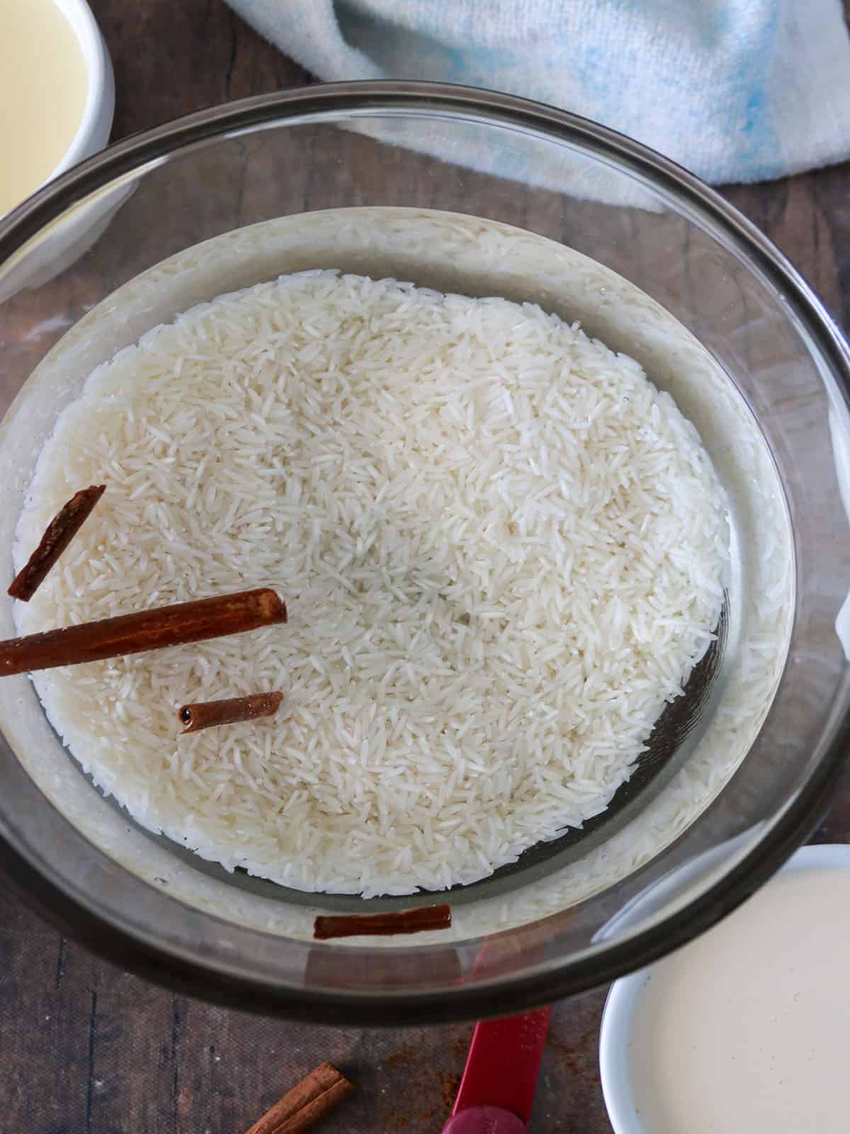 soaking rice and cinnamon sticks in a bowl of water