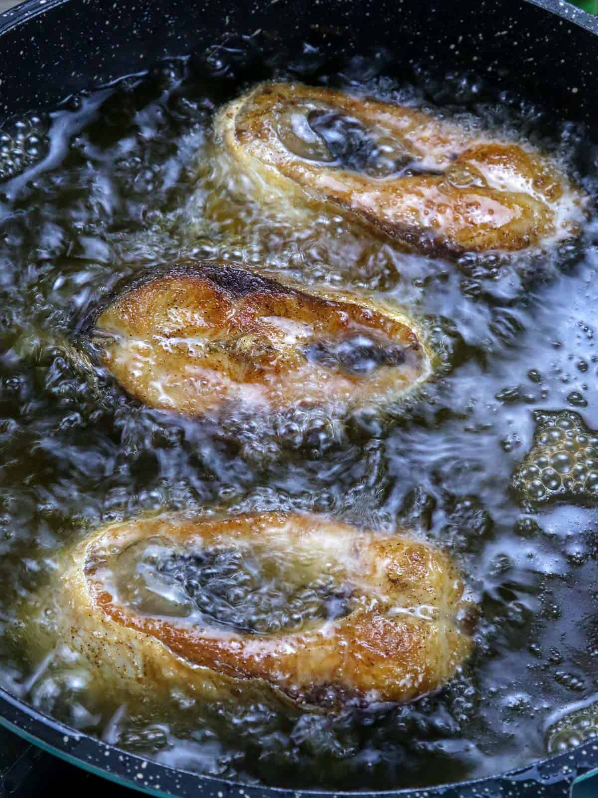 frying bangus in a pan