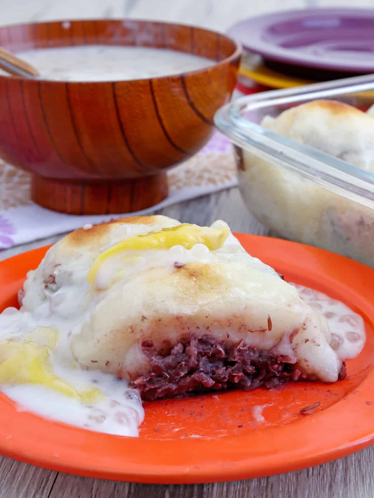 bibingkoy with ginataan sauce on an orange plate.