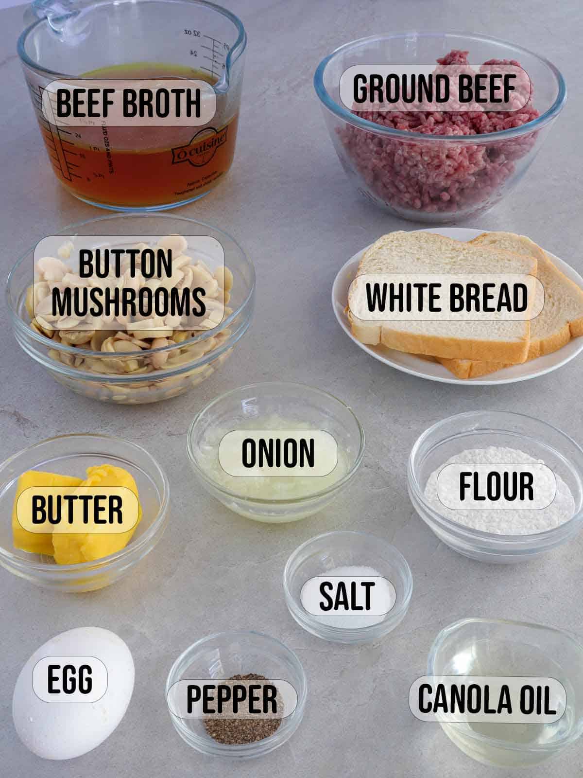 ground beef, beef broth, sliced mushrooms, bread, egg, flour, butter, salt, pepper, oil in bowls.