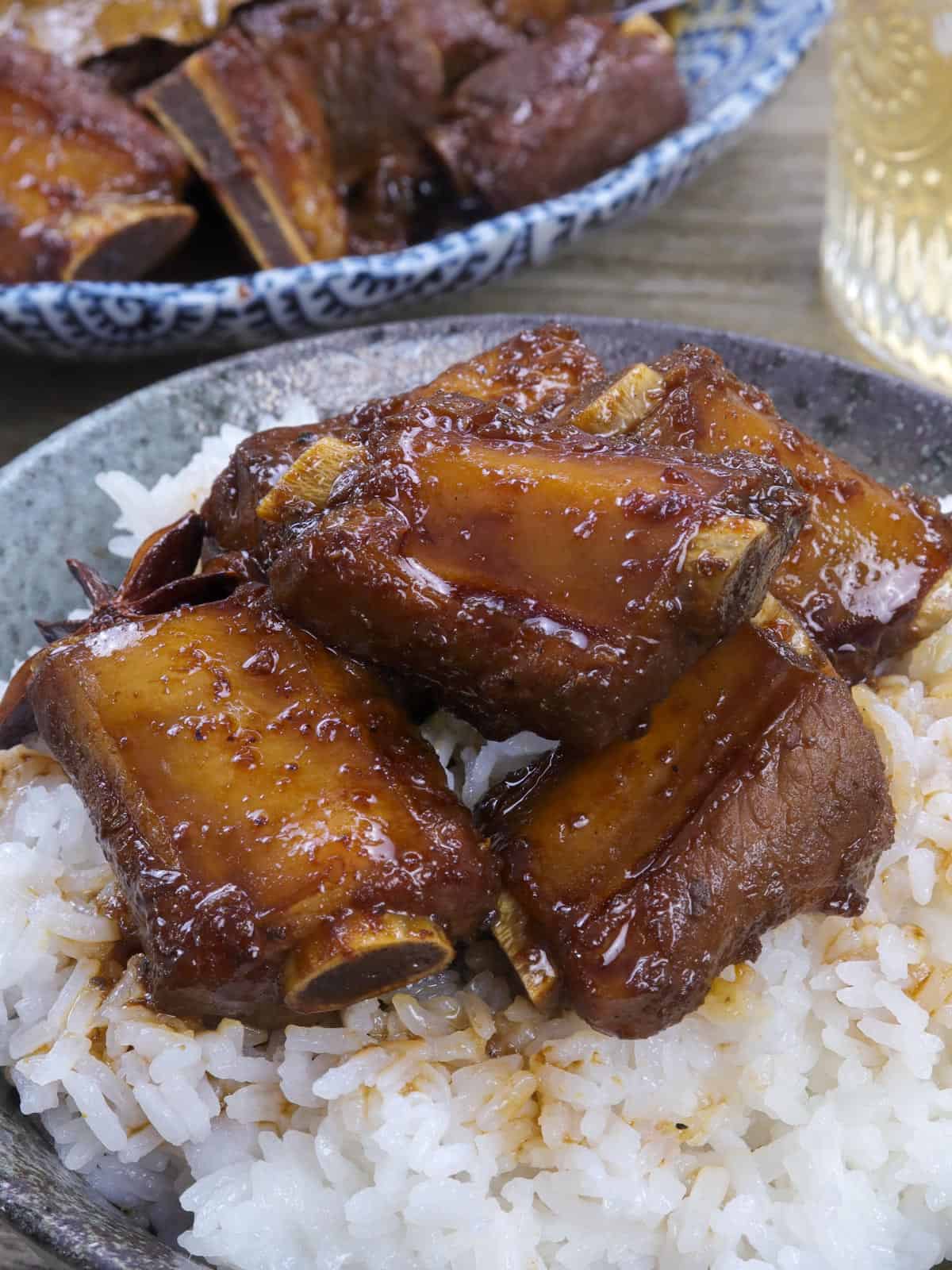 Pork Spareribs Macao-style Asado over steamed rice in a bowl.