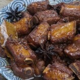 Chinese pork asado in a blue serving bowl.