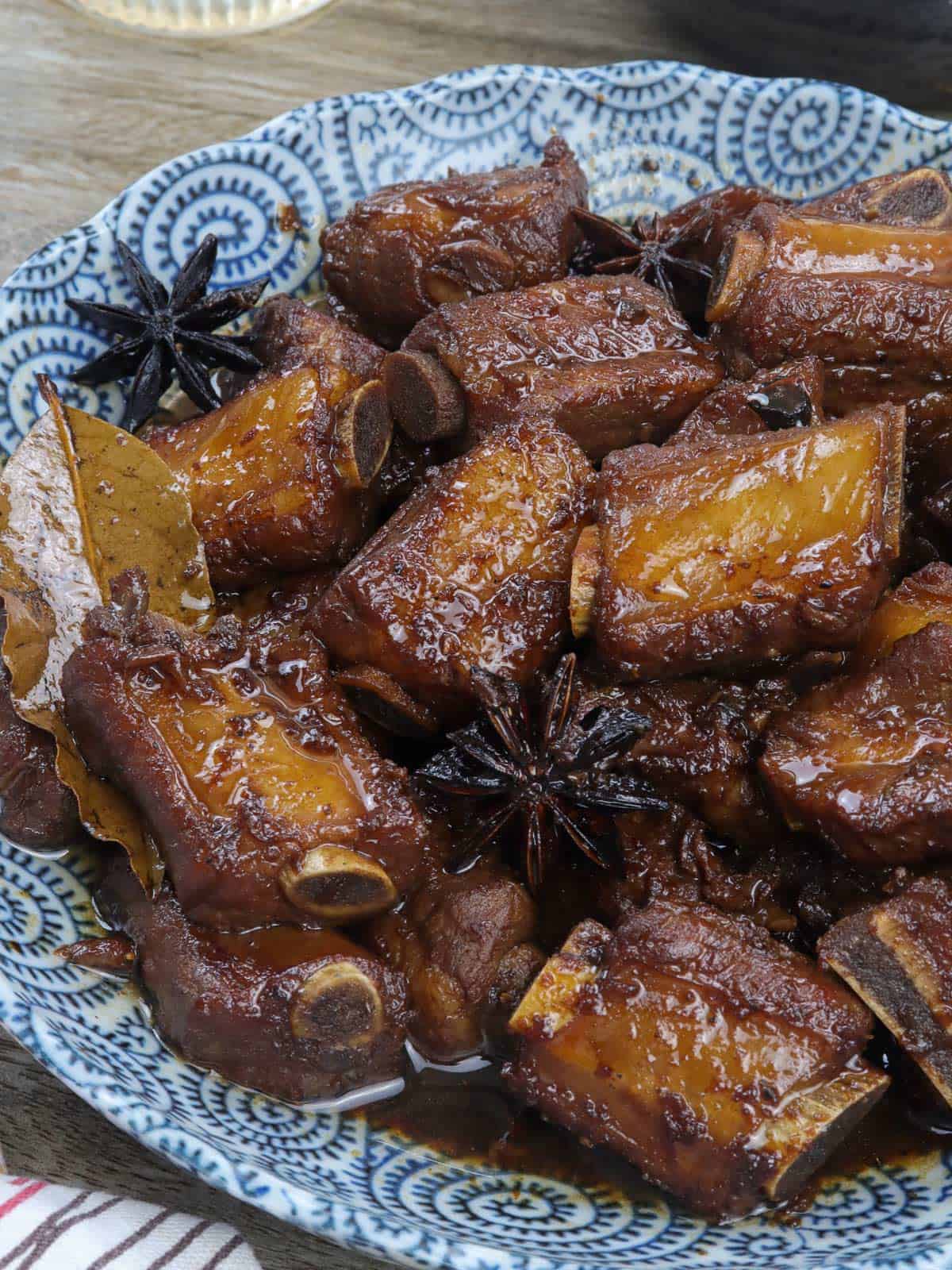 Chinese pork asado in a blue serving bowl.