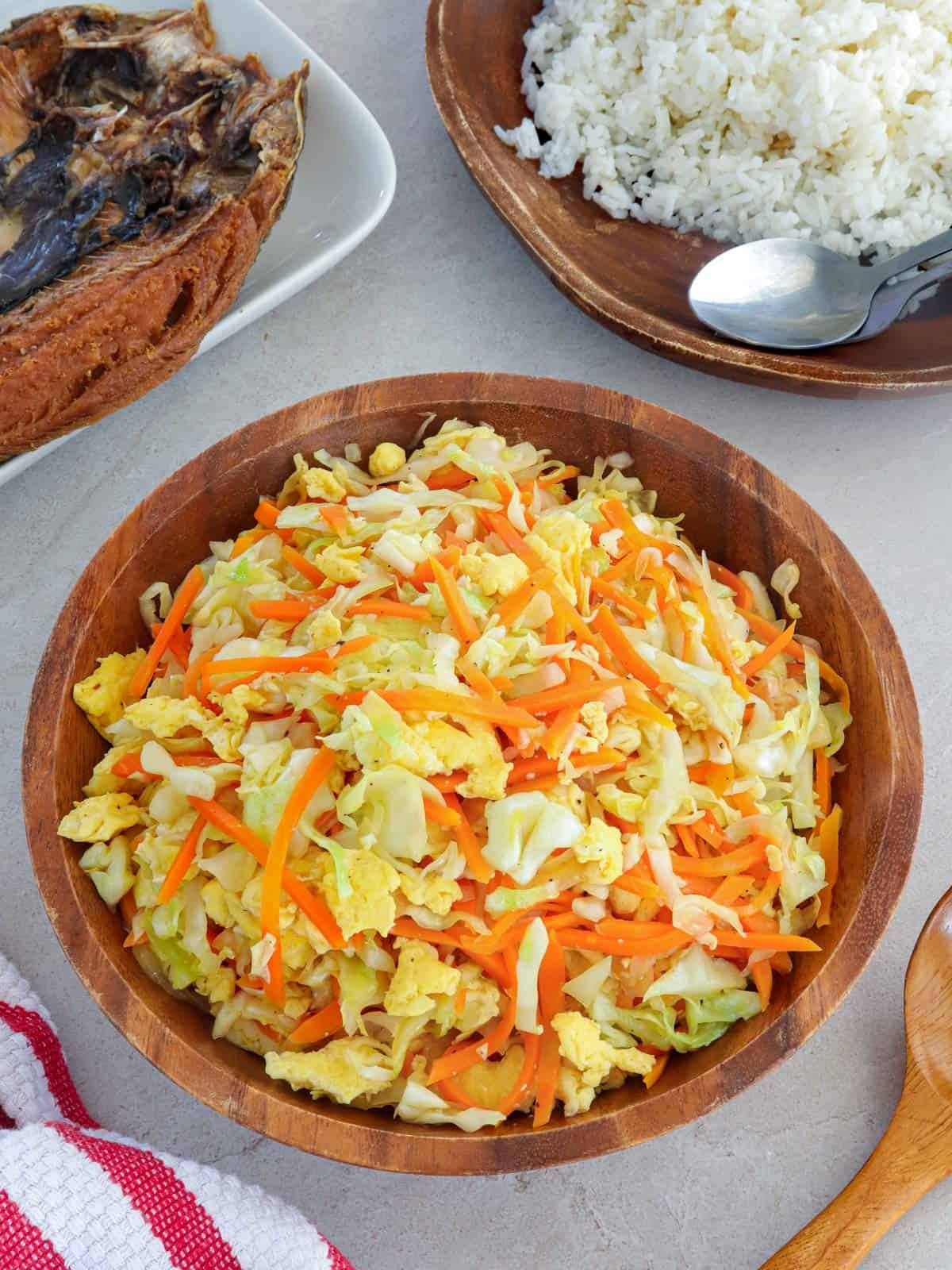 Ginisang Repolyo with Eggs in a wooden bowl.