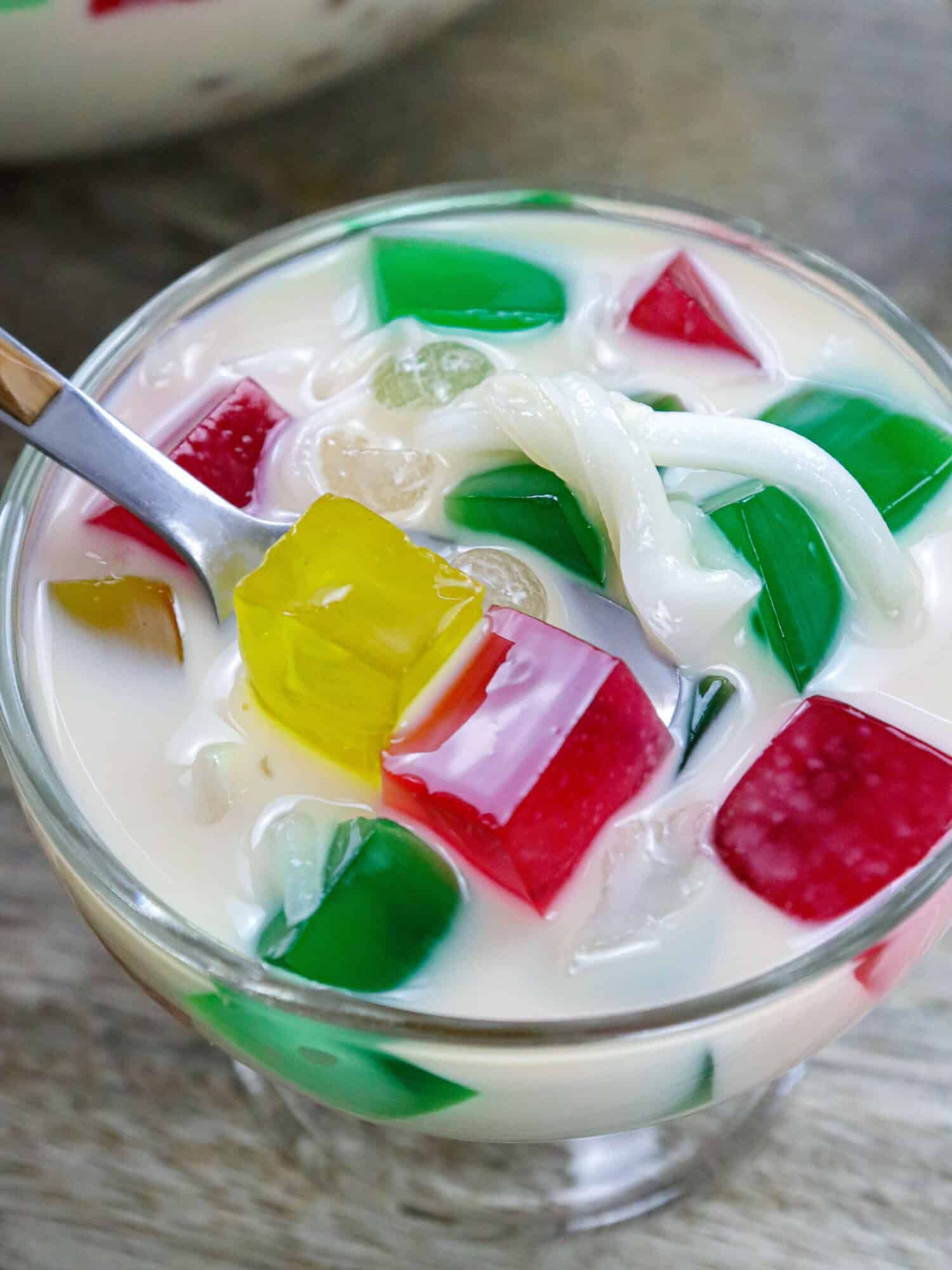 eating buko sago jelly salad with a spoon from a dessert cup.