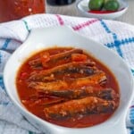 sardines in tomato sauce in a white serving bowl.