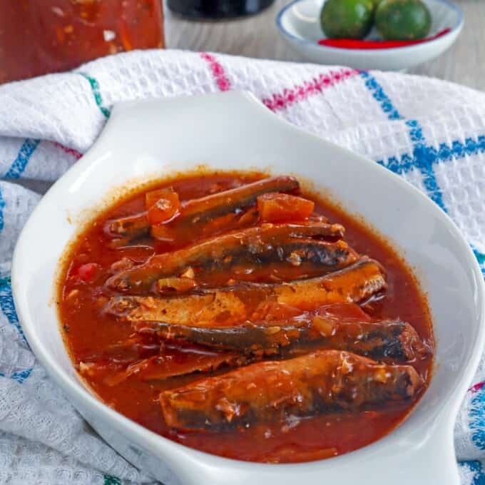 sardines in tomato sauce in a white serving bowl.