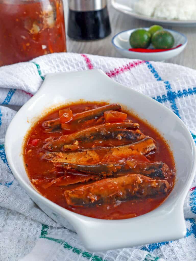 sardines in tomato sauce in a white serving bowl.